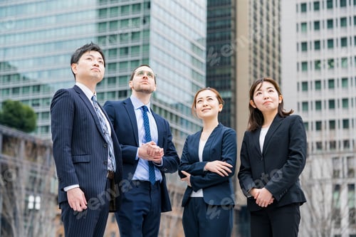 Preview: A Business Team Of Four Men And Women In Suits