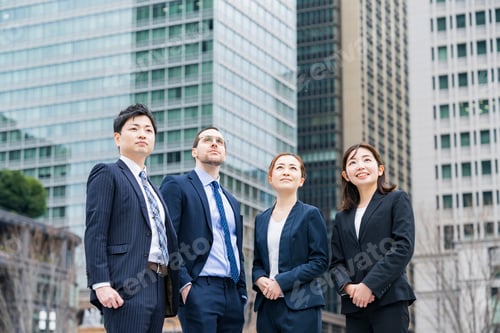 Preview: A Business Team Of Four Men And Women In Suits