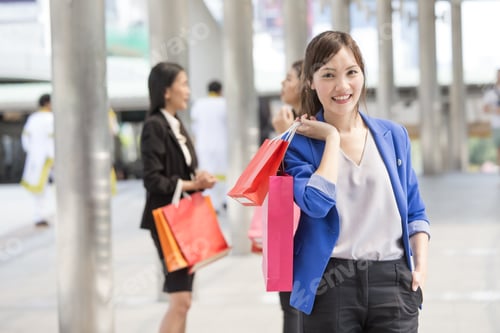 Preview: Asian Woman Holding Shopping Bag With Attractive Smile At City. Woman Shopping Concept.