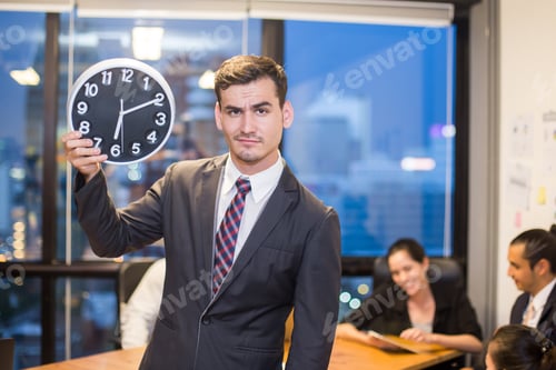 Preview: Businessman Stading And Holding Clock With Team While Meeting, Businessman Leader Concept, 20-30