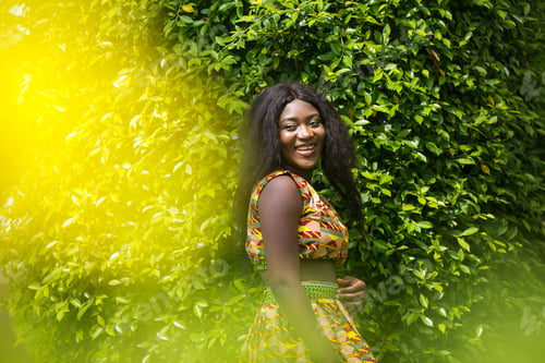 Preview: Woman In African-Print Dress In A Garden.