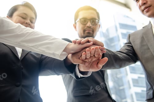 Vista previa: Low Angle View Of Business Team Stacking Hands In Office