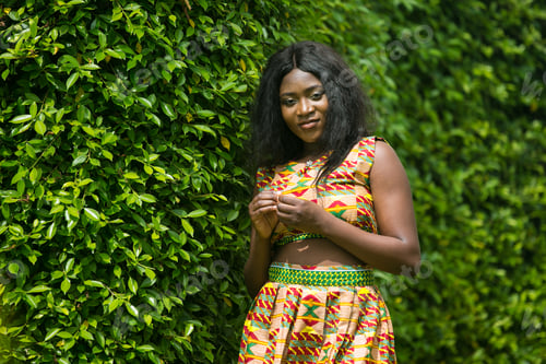 Preview: Woman In African-Print Dress In A Garden.