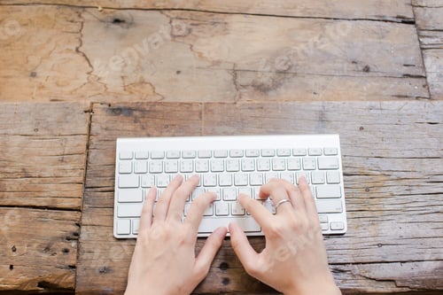 Preview: Woman Hand Typing Keyboard On Wood Background With Copy Space