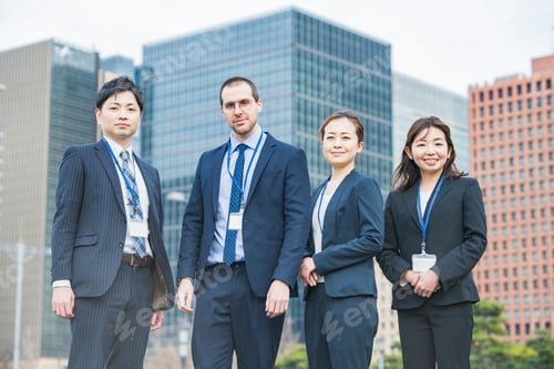Preview: A Business Team Of Four Men And Women In Suits