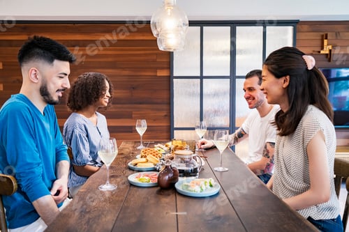 Preview: Scene Of A Home Party Where Men And Women Surround The Dining Table