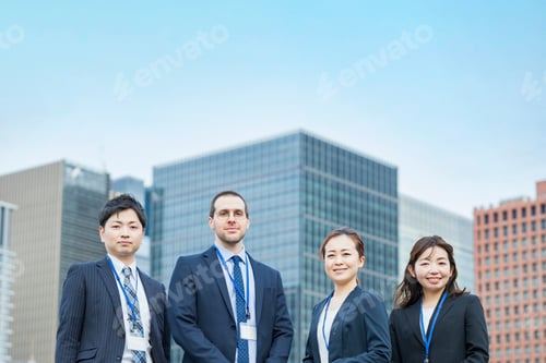 Preview: A Business Team Of Four Men And Women In Suits