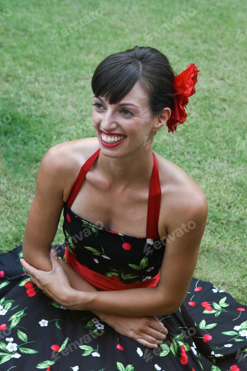 Preview: Portrait Of A Beautiful Brunette Woman Sitting On The Grass.