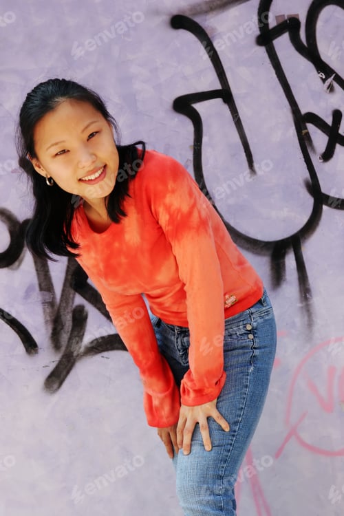 Preview: Korean Woman Wearing An Orange Top And Jeans - Graffiti Wall