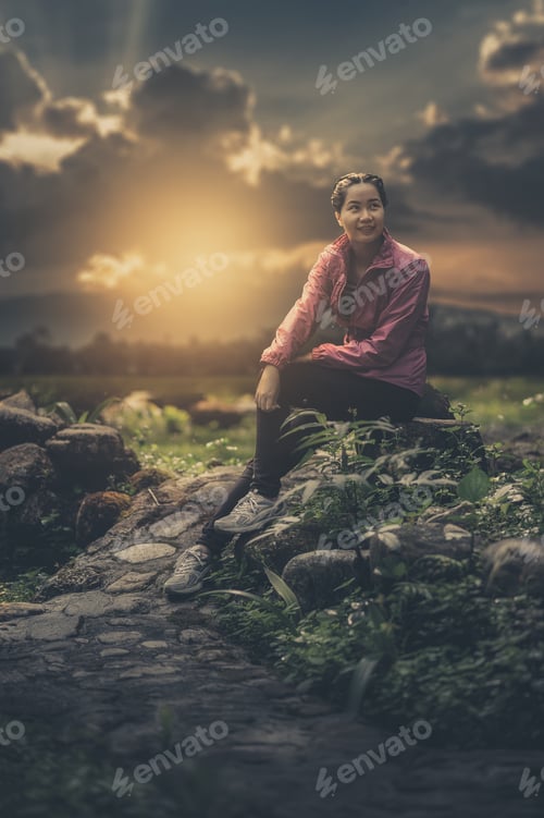 Preview: Vacation Lifestyle Scene Of Woman Wearing Sport Cloths Sitting In Park And Enjoy With Nature In