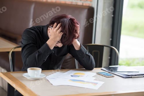 Preview: Business Man Sitting In Depression With Hand On Head