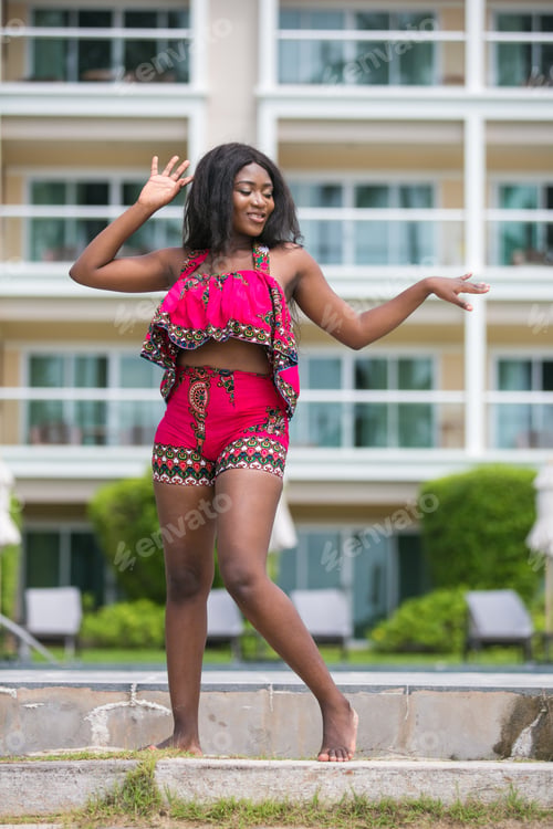 Preview: African Woman In Modern Ethnic Dress Relaxing At A Resort.