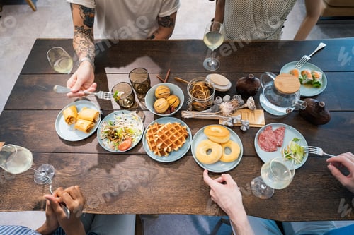 Preview: Scene Of A Home Party Where Men And Women Surround The Dining Table