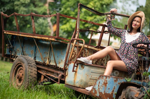 Preview: Young Woman Sitting On Abandoned Vehicle At Field