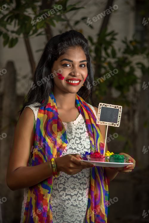Preview: Young Girl Holding Powder Colors In Plate On The Festival Of Colors Called Holi, A Popular Hindu