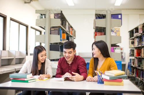 Preview: Group Of Student Reading Books In The Library With Attractive Smiling Together . People With