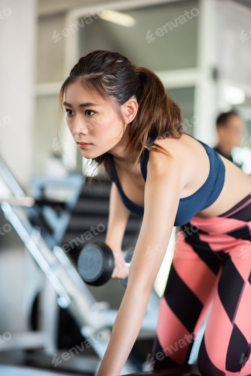 Preview: Fitness Woman In Training Exercises With Dumbbells.