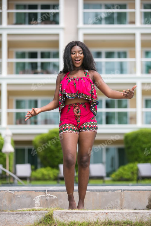 Preview: African Woman In Modern Ethnic Dress Relaxing At A Resort.