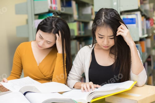 Preview: Woman In The Foreground Is Reading A Books. Young Asian Woman Are Reading In The Modern Library
