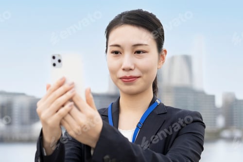 Preview: Business Woman Operating A Smartphone