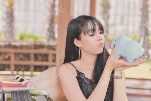 Preview: Business Concept. Beautiful Business Woman Saving Money In A Piggy Bank. Beautiful Businesswoman