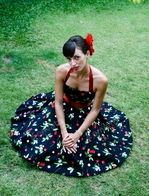 Preview: Portrait Of A Beautiful Brunette Woman Sitting On The Grass.