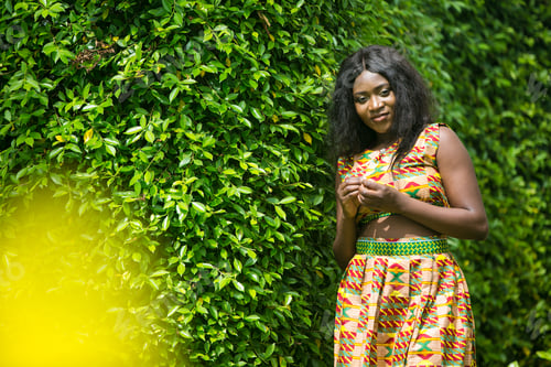 Preview: Woman In African-Print Dress In A Garden.