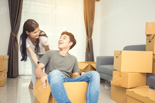 Preview: Happy Asian Couple Is Playing Together With Cardboard Boxes In New House At Moving Day. Vintage