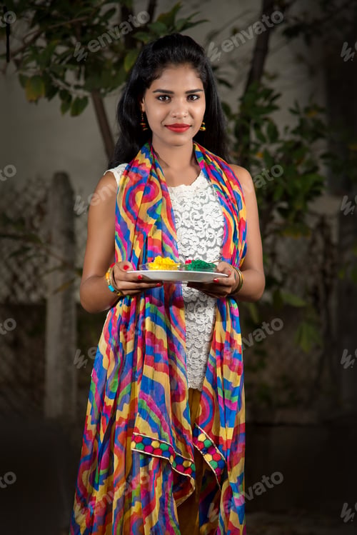 Preview: Young Girl Holding Powder Colors In Plate On The Festival Of Colors Called Holi, A Popular Hindu