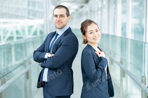 Preview: Businessman And Businesswoman Standing Back To Back