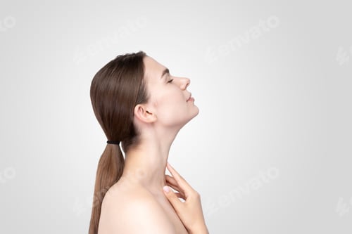 Preview: Asian Young Woman Touching Face With Her Hand In Relaxed Expression