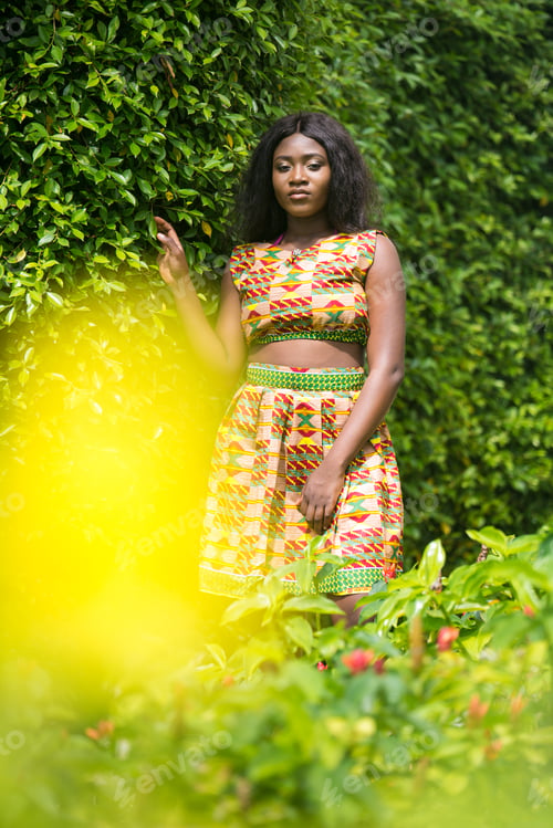 Preview: Woman In African-Print Dress In A Garden.