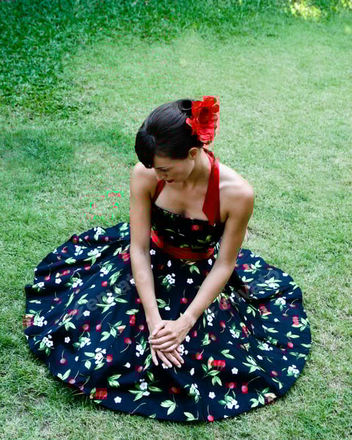 Preview: Portrait Of A Beautiful Brunette Woman Sitting On The Grass.