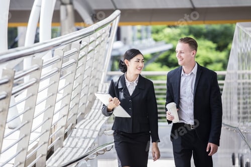 Preview: Happy Asian Businesswoman Walking And Talk About Work With Businessman. People Work At Outdoor