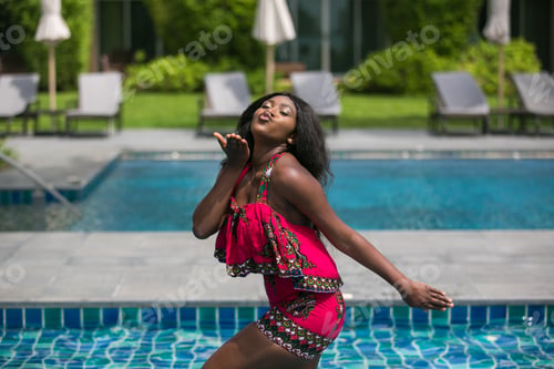 Preview: African Woman In Modern Dress Relaxing By The Pool.