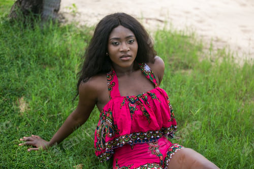Preview: Woman In African-Print Dress In A Garden.