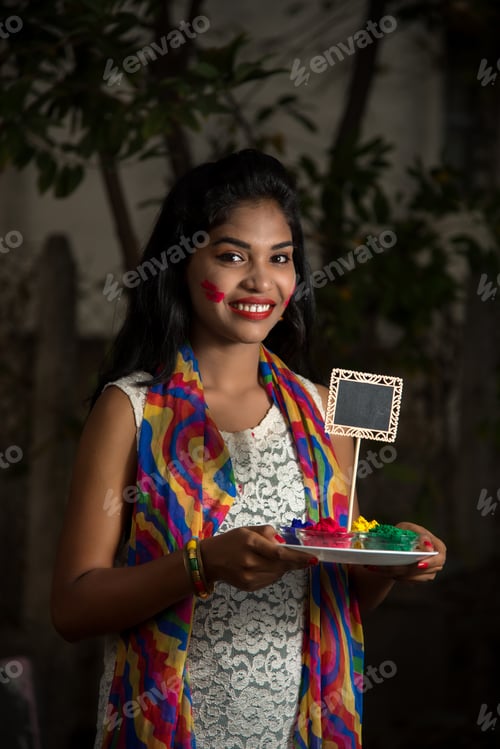 Preview: Young Girl Holding Small Board And Powdered Color On The Occasion Of Holi Festival.