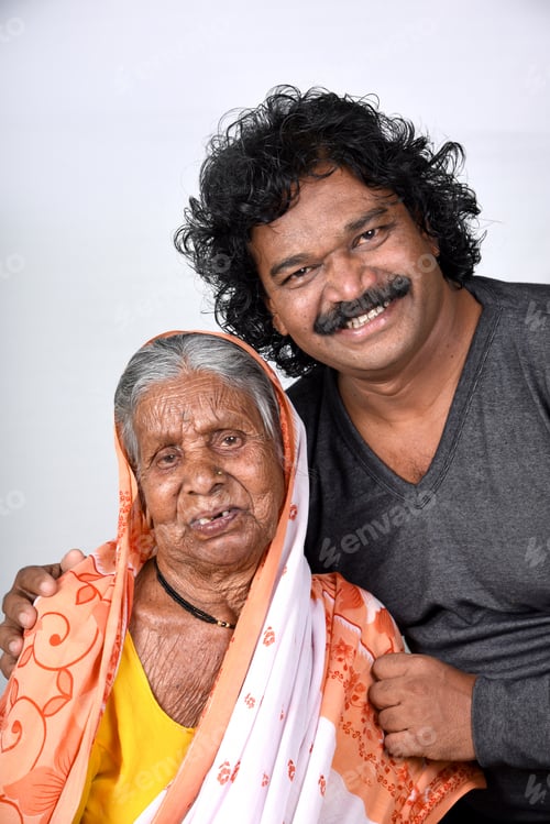 Preview: Adult Son And His Aging Mother. India Senior Woman With Her Son On White