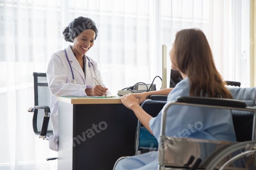 Preview: Doctor And Patient Discussing While Sitting At Hospital