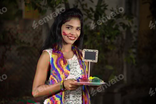 Preview: Young Girl Holding Small Board And Powdered Color On The Occasion Of Holi Festival.