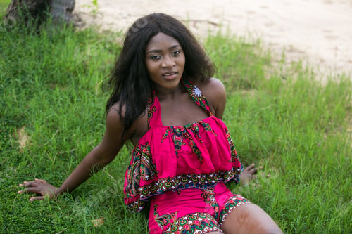 Preview: Woman In African-Print Dress In A Garden.