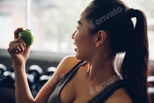 Preview: Attractive Smiling Young Asian Woman Holding Green Apple To Eat. Healthy Concept.