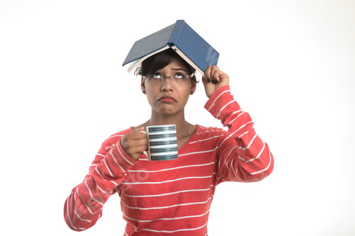 Preview: Beautiful Young Girl With Book And Cup Of Tea Or Coffee Posing On A White Background.