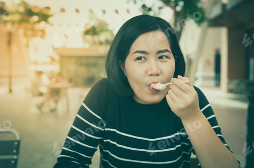 Preview: Adult Asian Woman Eating Dessert At Coffee Shop On Weekend. Urban Lifestyle On Weekend Concept With