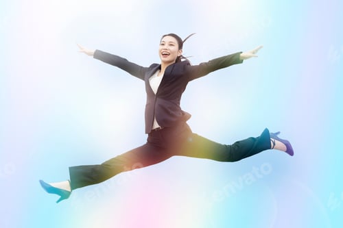 Preview: A Young Business Woman In A Suit Jumping With A Smile