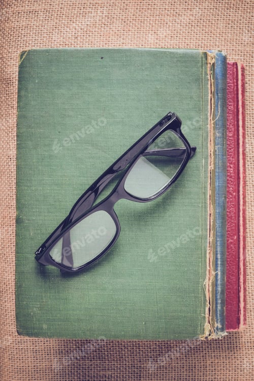 Preview: Vintage Books and Eyeglasses Still Life Composition
