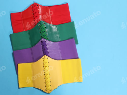 Preview: Colorful Corset Belts On Blue Background