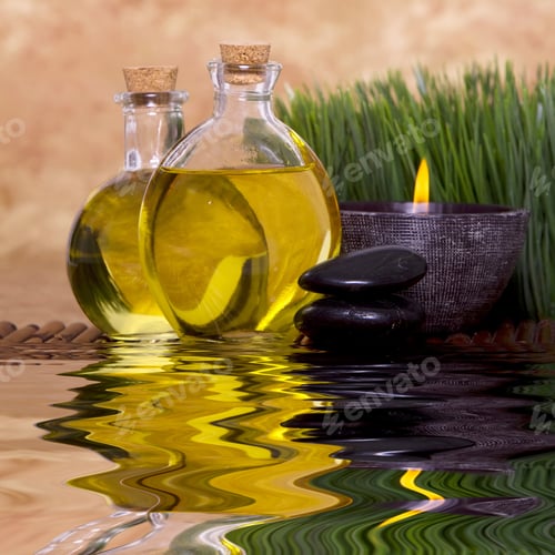 Preview: Relaxing Candle And Massage Oil Bottles Front Of Green Grass