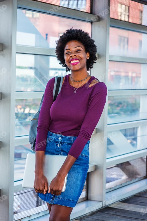 Preview: African American College Student With Afro Hairstyle, Wearing Long Sleeve T Shirt, Denim Skirt