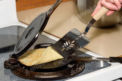 Preview: Woman Making Cookies With A Norwegian Krumkake Iron